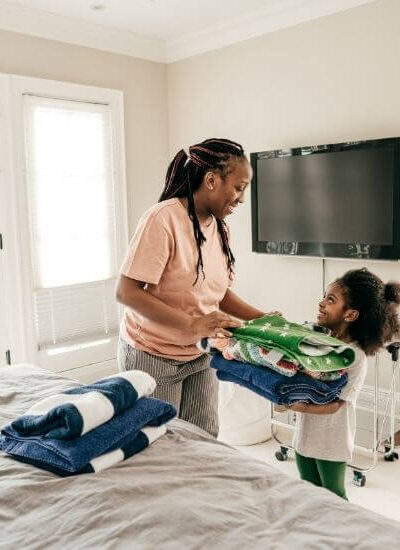 Daughter helping mother with laundry