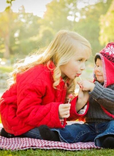 Child sharing a sucker to be kind