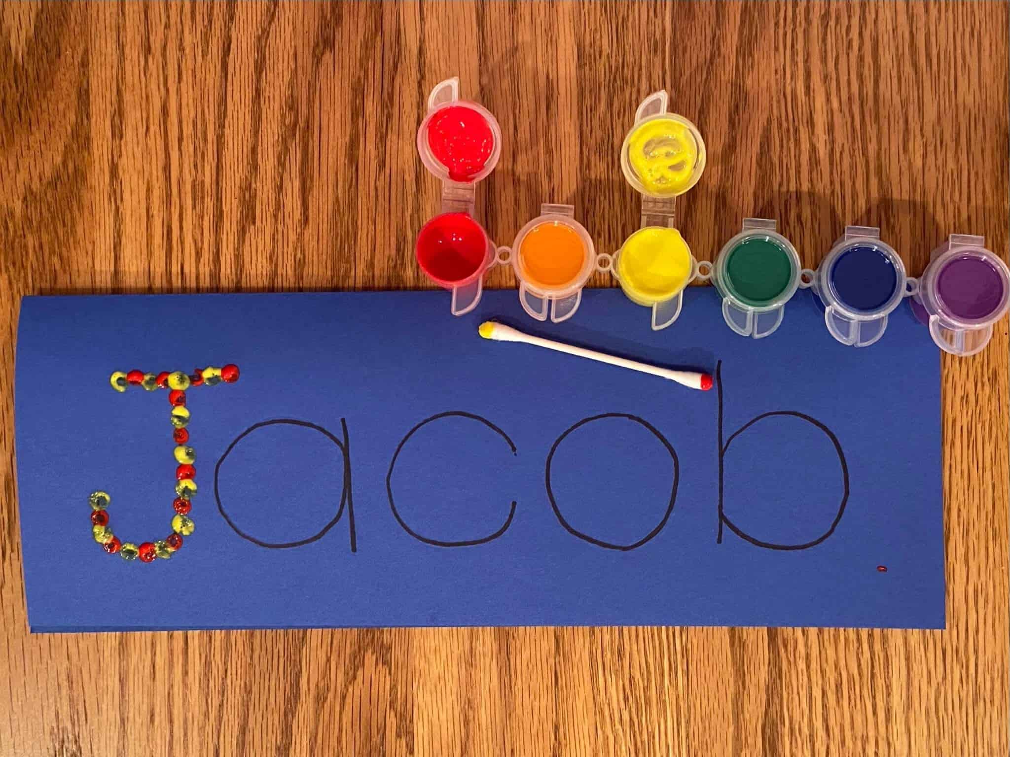 Image of Using qtips and paint to write name 