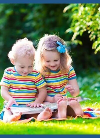 Toddlers reading outside