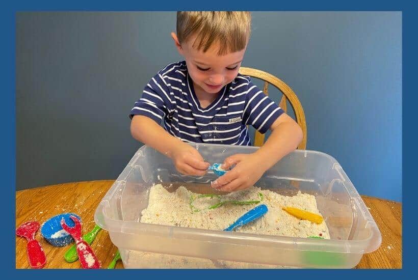 Boy playing with cupcake sensory bin