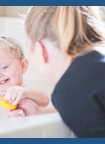 Mom using bath time as teaching time for child in bath