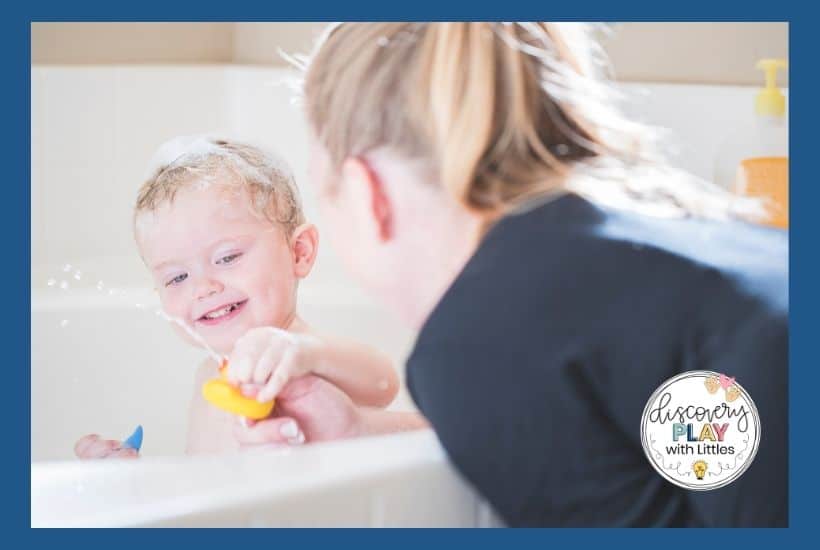 Mom using bath time as teaching time for child in bath