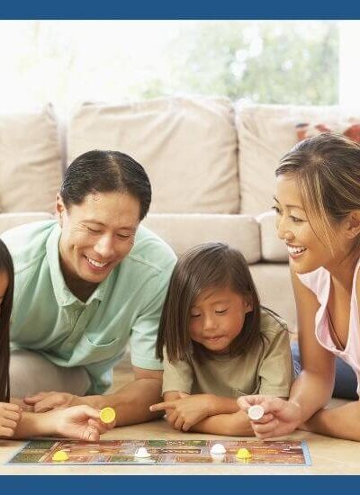 Family playing board game with 3 year old