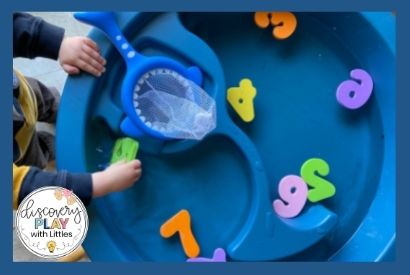 Image of toddler playing with numbers in water table for number recognition