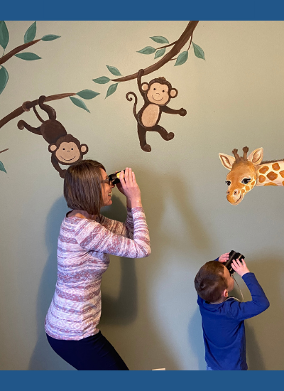 Image of preschooler looking at safari animals